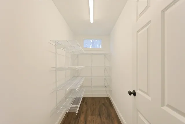 a living room with furniture a flat screen tv and a large window