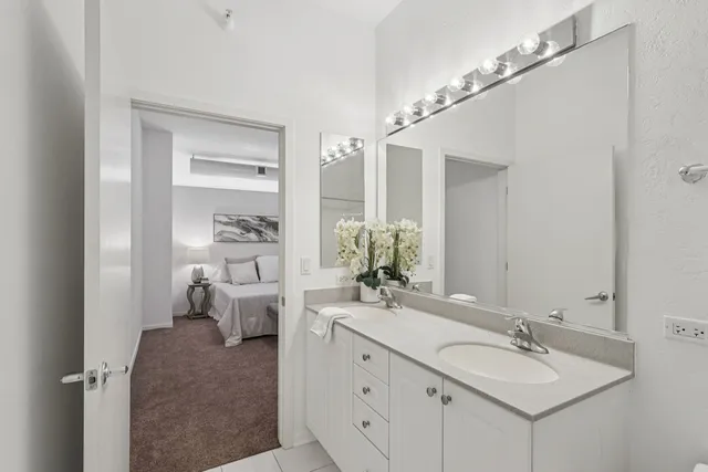 a spacious bathroom with a double vanity sink and a mirror