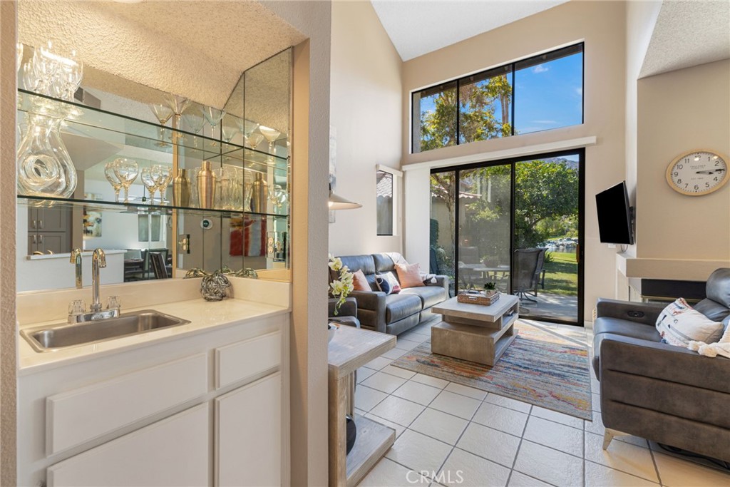 79822 Olympia Fields La Quinta, CA 92253 - Photo 11 of 48 a living room with furniture large windows and a flat screen tv