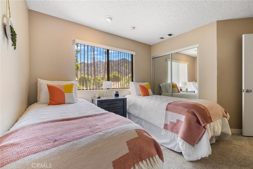 79822 Olympia Fields La Quinta, CA 92253 - Photo 30 of 48 a bedroom with two beds and large windows