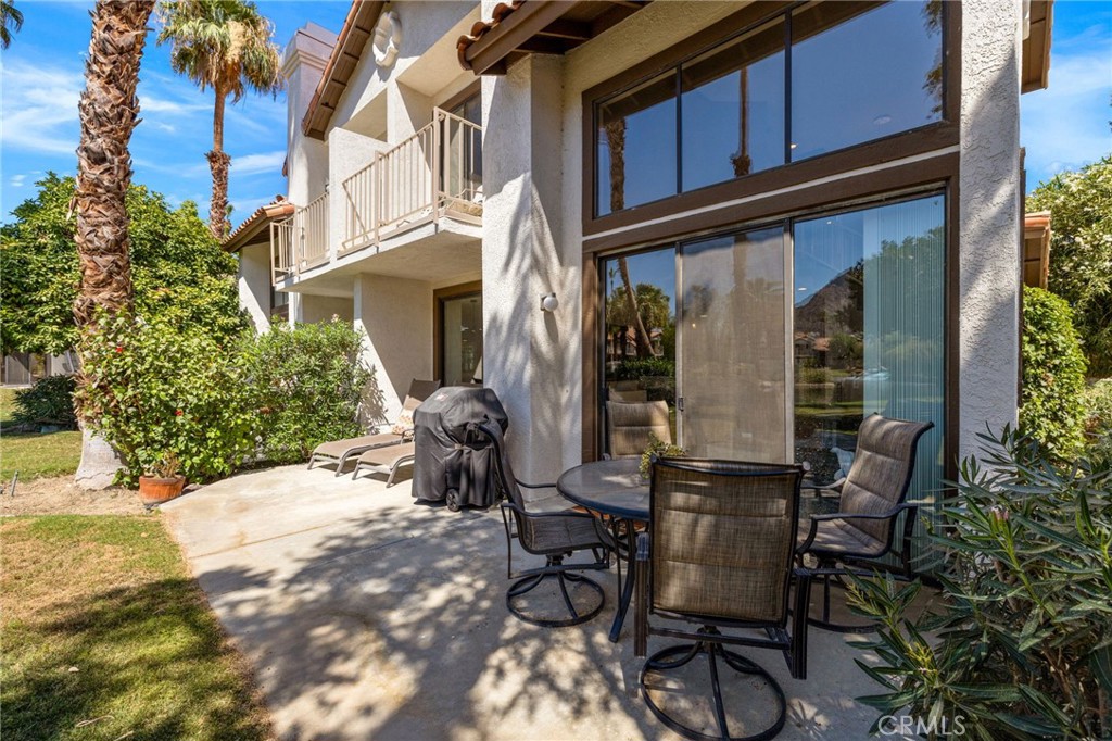 79822 Olympia Fields La Quinta, CA 92253 - Photo 37 of 48 a view of patio with table and chairs and potted plants