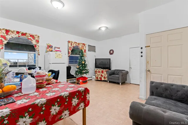 a bedroom with furniture a flat screen tv and a fireplace