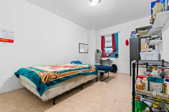 a living room with furniture and a baby crib