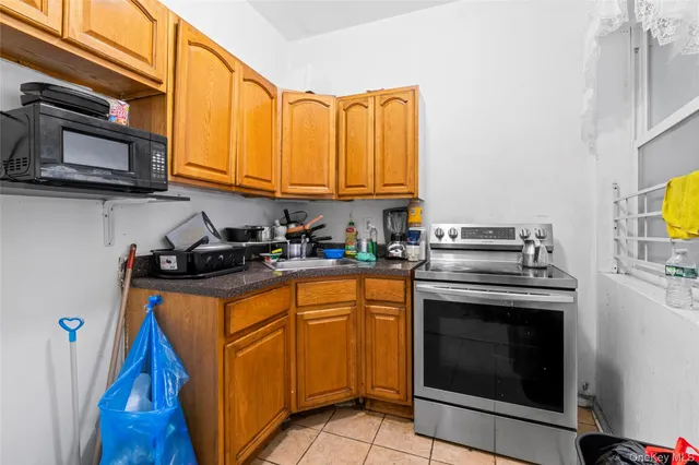 a kitchen with stainless steel appliances granite countertop a stove microwave and sink