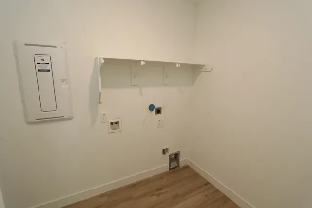 a front view of a house with a yard and potted plants