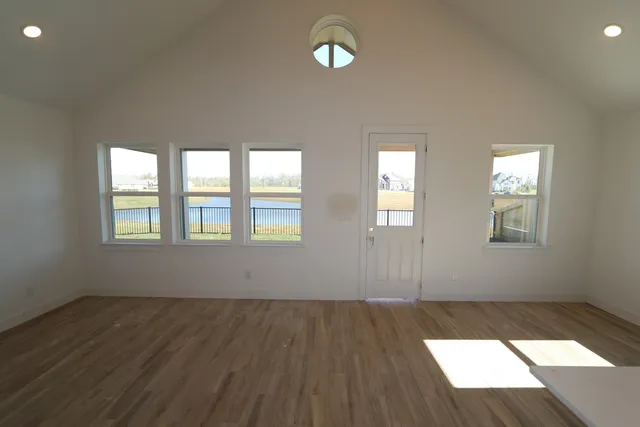 a view of a room with wooden floor