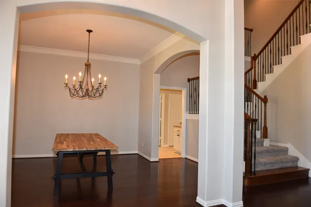 a view of a hallway with wooden floor and staircase