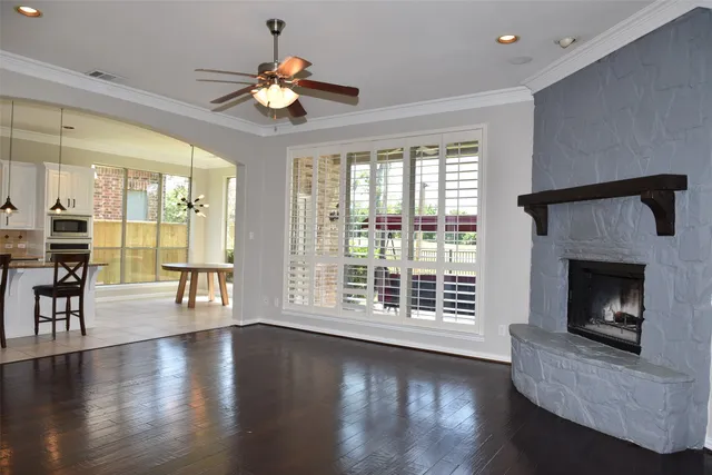 a living room with wooden floors and a fireplace