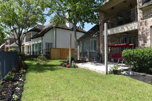 a view of a house with a yard and tree s