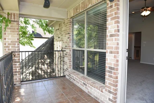 a view of front door and porch with wooden floor