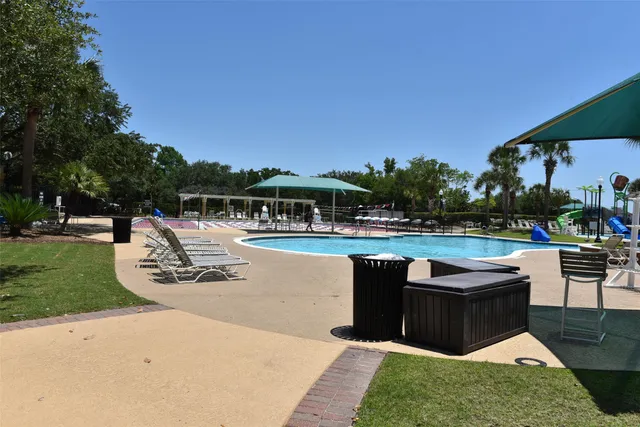 a view of swimming pool with outdoor seating and plants