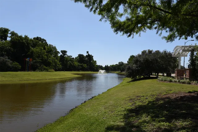 a view of a lake with houses in the background
