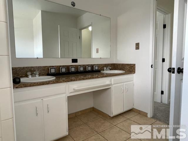 102 Smithridge Reno, NV 89502 - Photo 14 of 20 a kitchen with white cabinets and sink