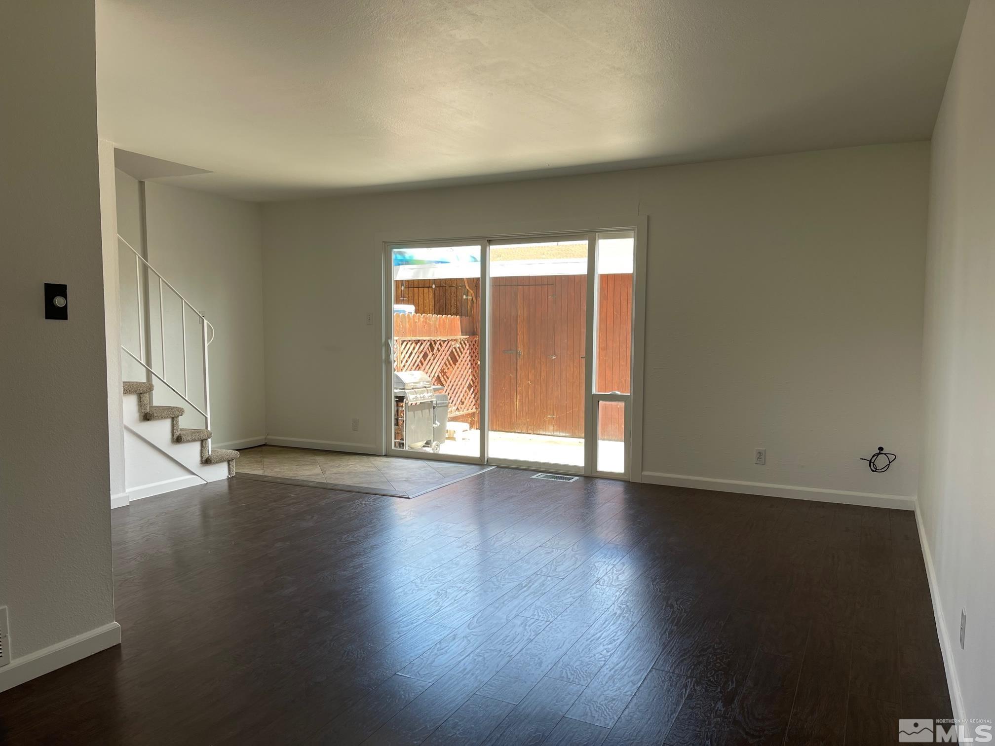 102 Smithridge Reno, NV 89502 - Photo 3 of 20 an empty room with wooden floor and windows