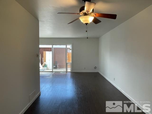 102 Smithridge Reno, NV 89502 - Photo 5 of 20 a view of an empty room with a window and wooden floor