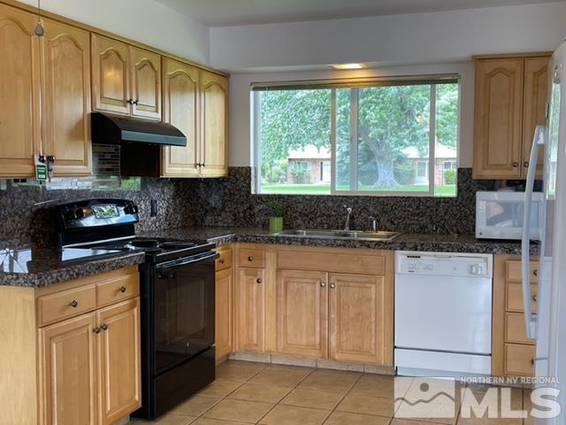 102 Smithridge Reno, NV 89502 - Photo 6 of 20 a kitchen with stainless steel appliances granite countertop a stove a sink and a microwave