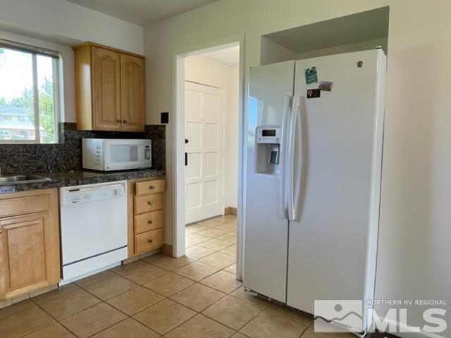 102 Smithridge Reno, NV 89502 - Photo 7 of 20 a view of kitchen with granite countertop cabinets and refrigerator