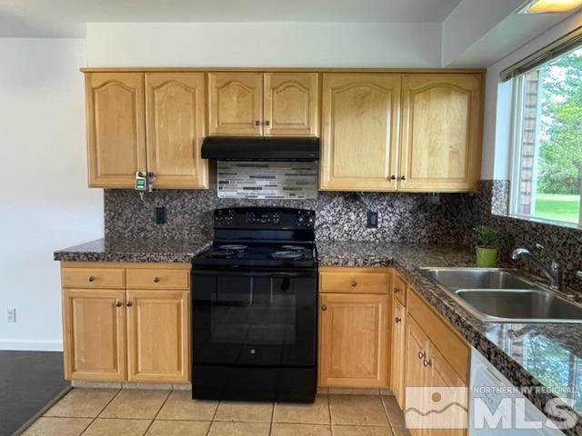102 Smithridge Reno, NV 89502 - Photo 8 of 20 a kitchen with granite countertop a sink stove and cabinets