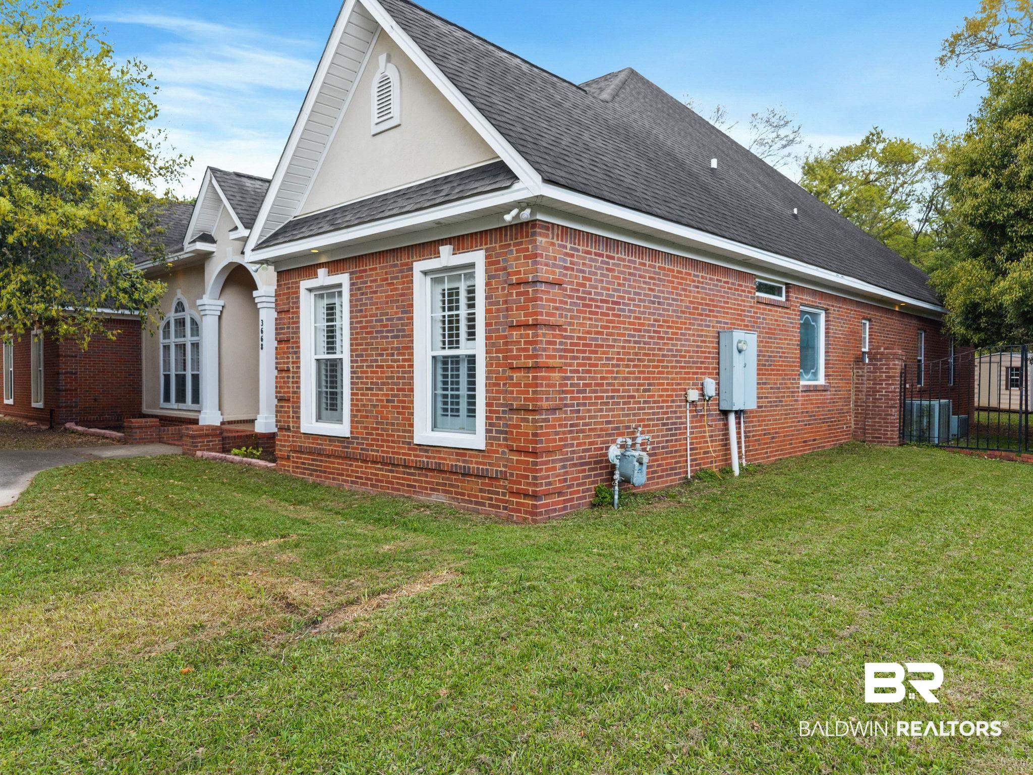 3668 Claridge Road North Mobile, AL 36608 - Photo 14 of 100 View of home's exterior featuring roof with shingles, brick siding, and stucco siding