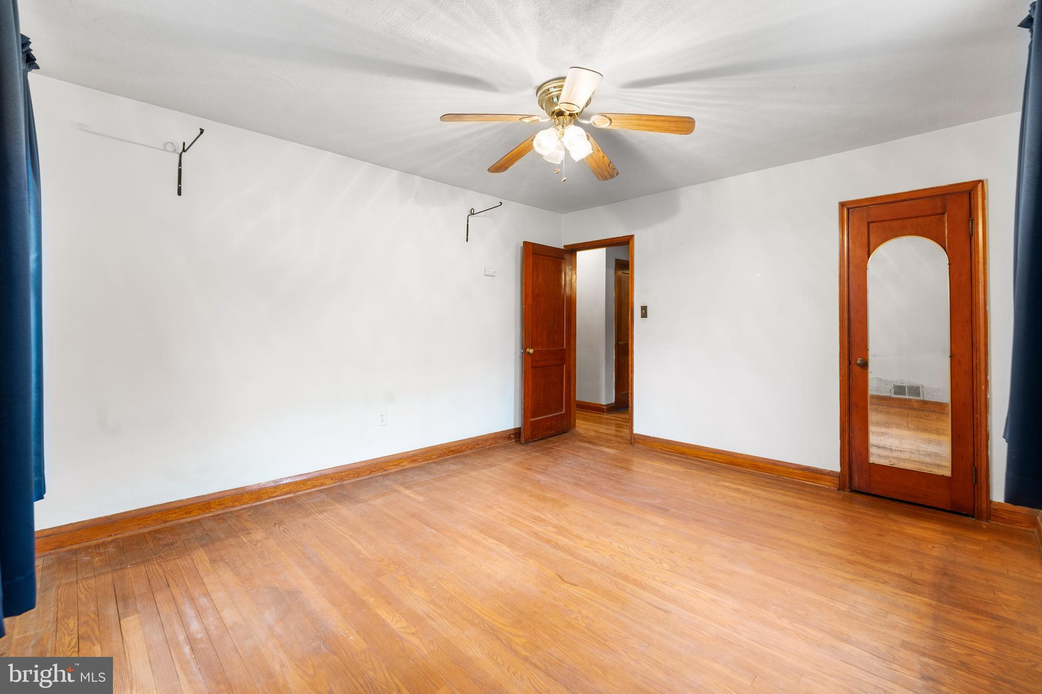 24 Mansion Road Linthicum Heights, MD 21090 - Photo 14 of 35 a view of an empty room with window and wooden floor