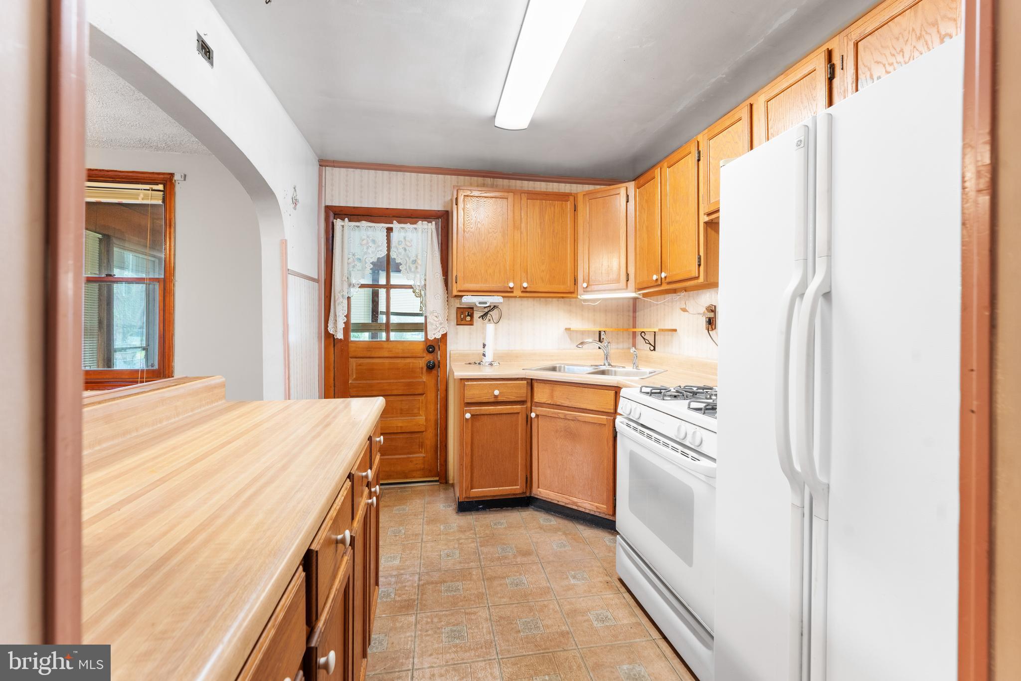 24 Mansion Road Linthicum Heights, MD 21090 - Photo 18 of 35 a kitchen with a window a sink and a refrigerator