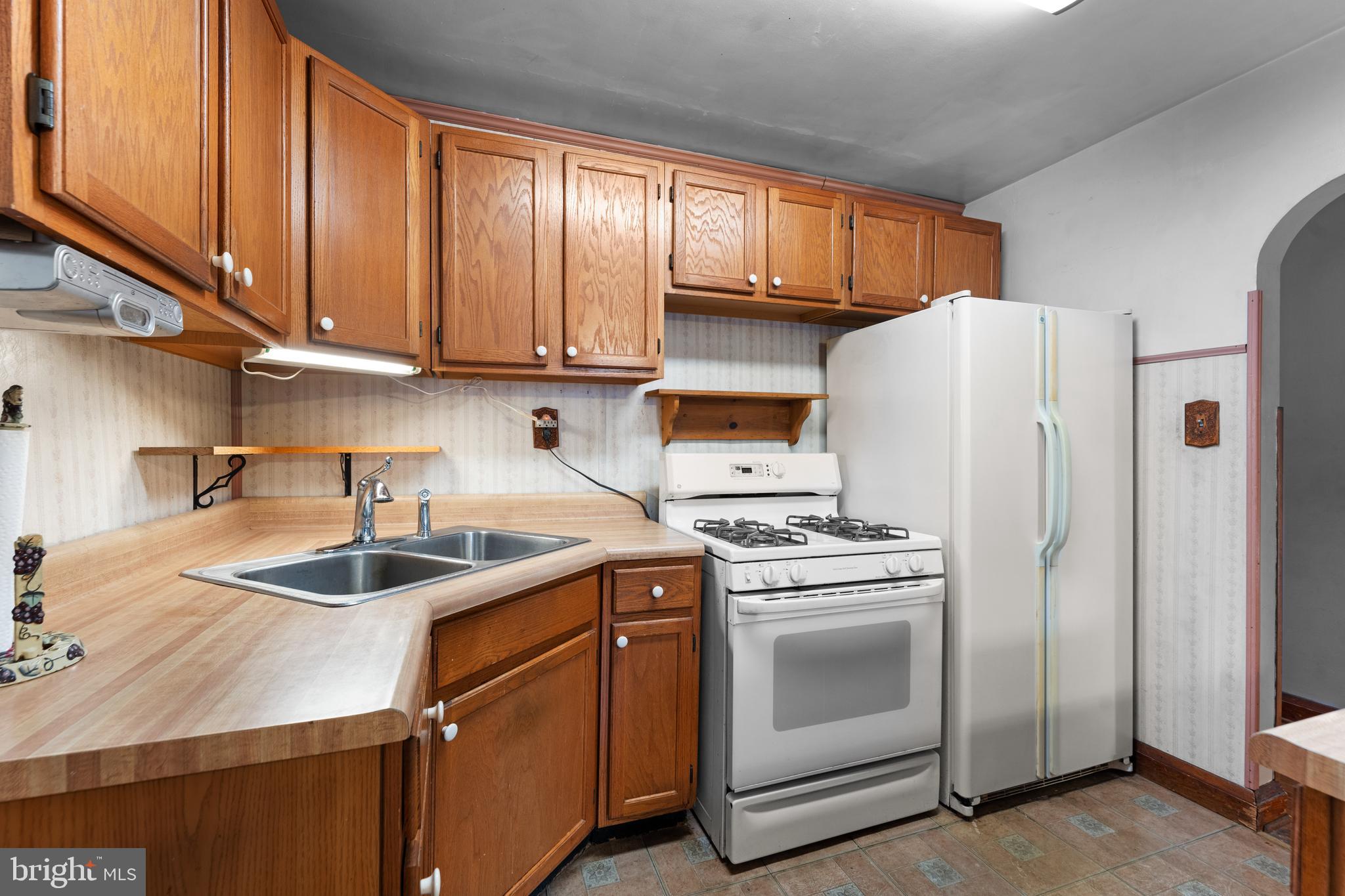 24 Mansion Road Linthicum Heights, MD 21090 - Photo 19 of 35 a kitchen with a sink a refrigerator and cabinets