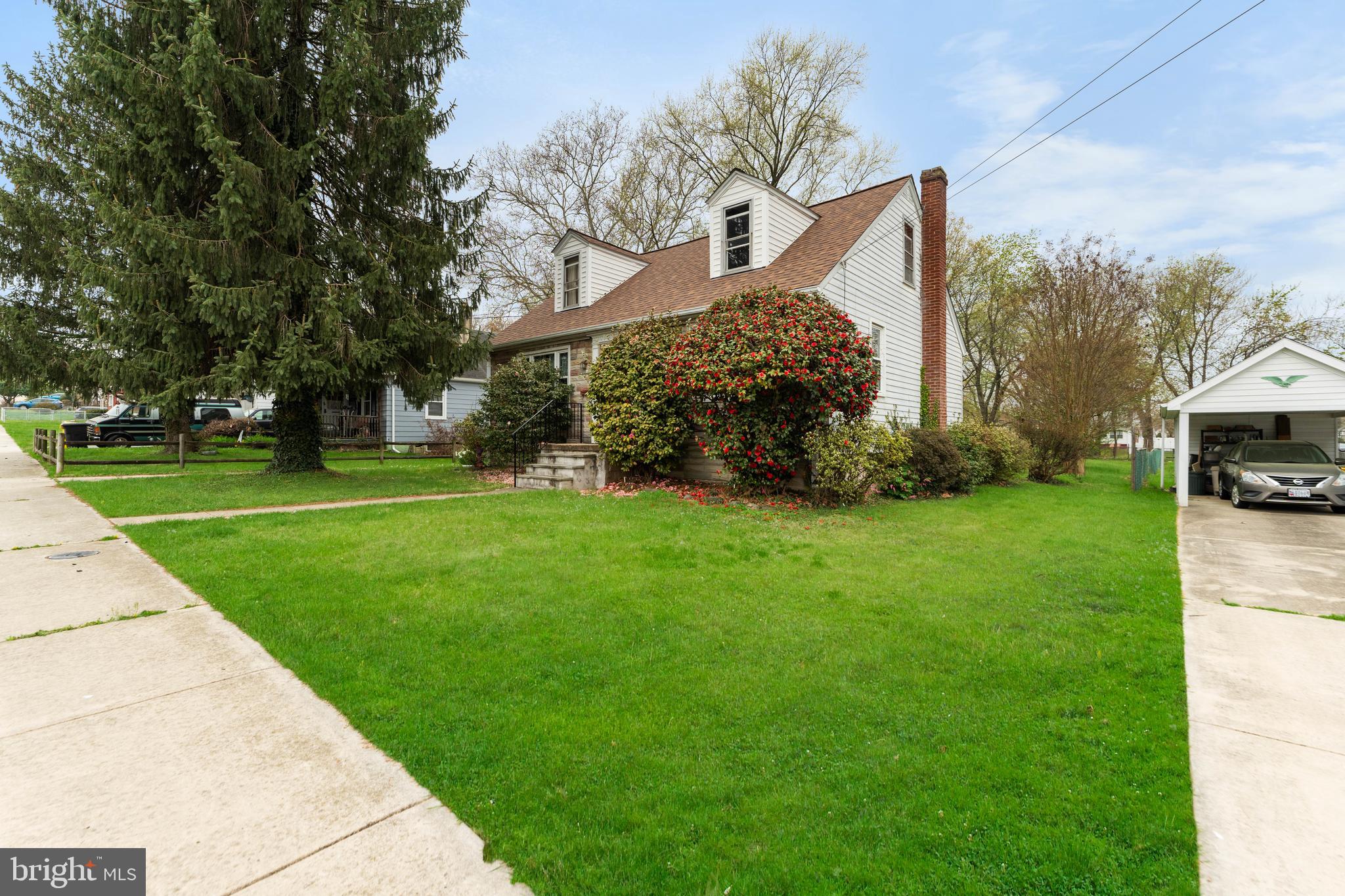 24 Mansion Road Linthicum Heights, MD 21090 - Photo 3 of 35 a front view of a house with a yard and potted plants