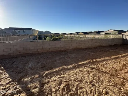 a view of a yard with wooden fence