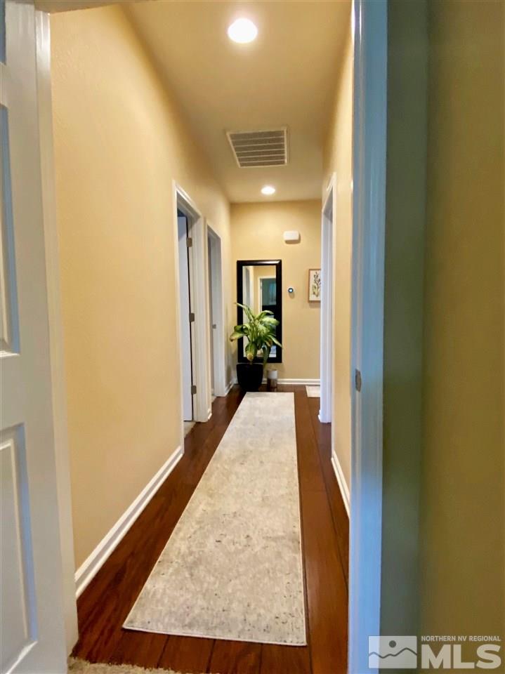 590 Needles Court Reno, NV 89521 - Photo 11 of 15 a view of a hallway with wooden floor and a living room