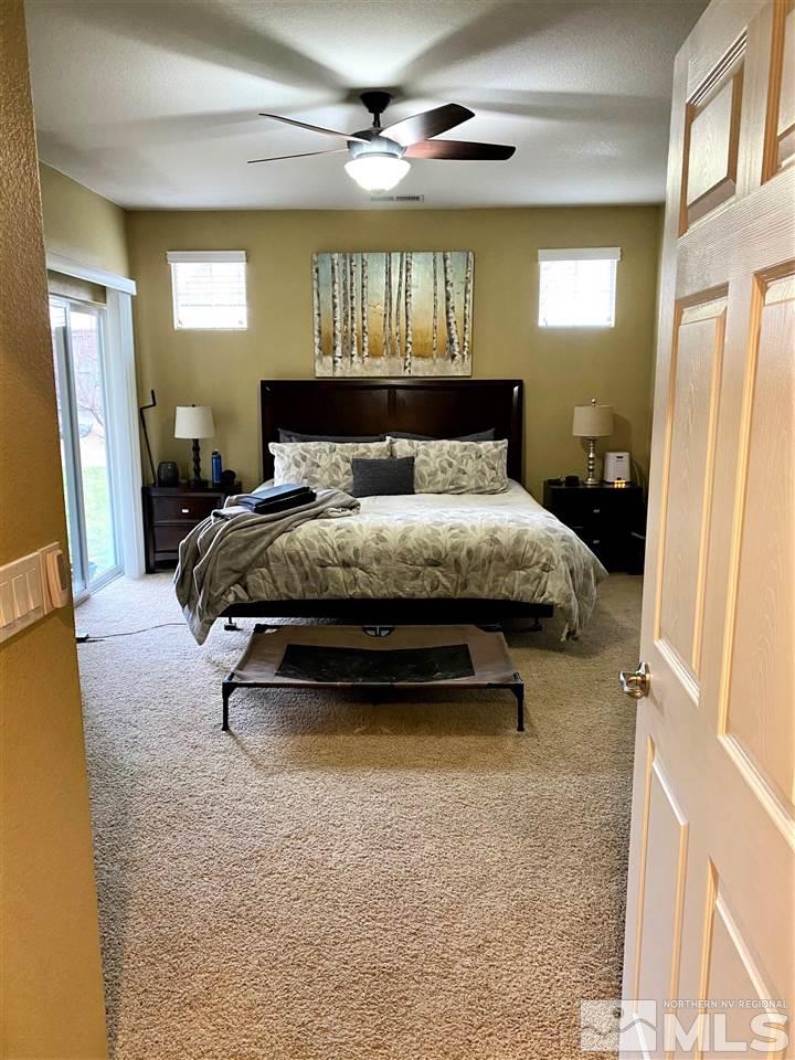 590 Needles Court Reno, NV 89521 - Photo 8 of 15 a bedroom with a bed and a chandelier