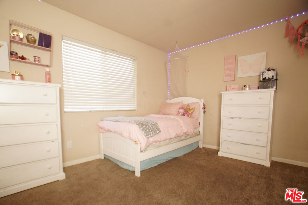 6014 Samuelson Street Bakersfield, CA 93313 - Photo 14 of 25 a bedroom with a bed and a window
