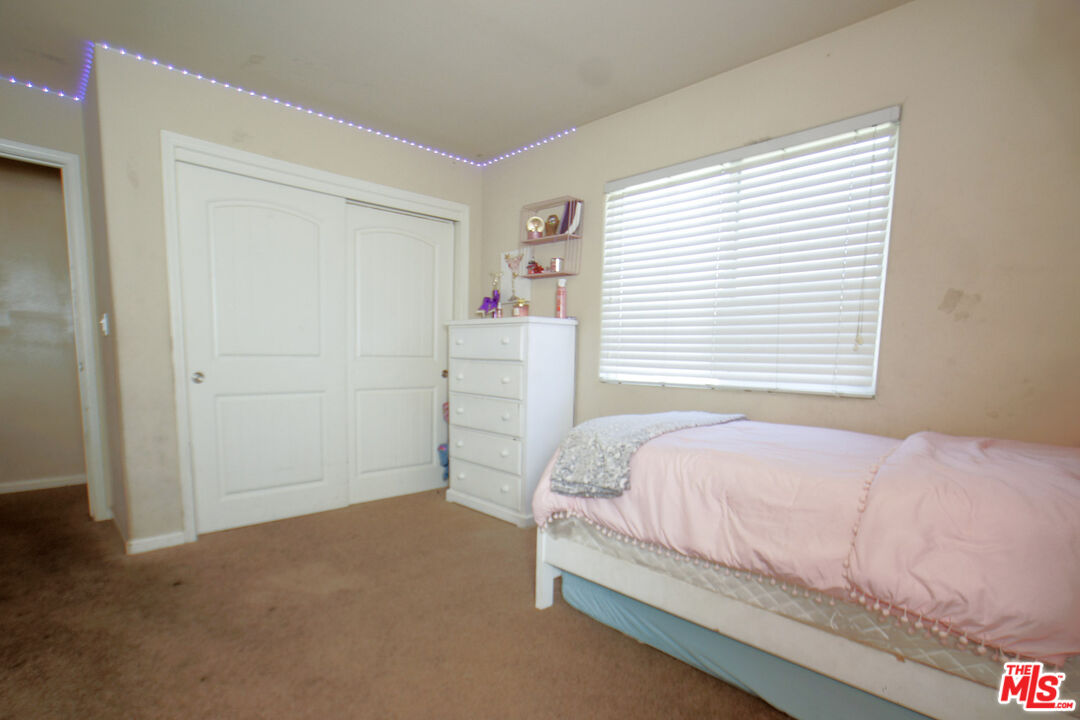 6014 Samuelson Street Bakersfield, CA 93313 - Photo 15 of 25 a bedroom with a bed and a window