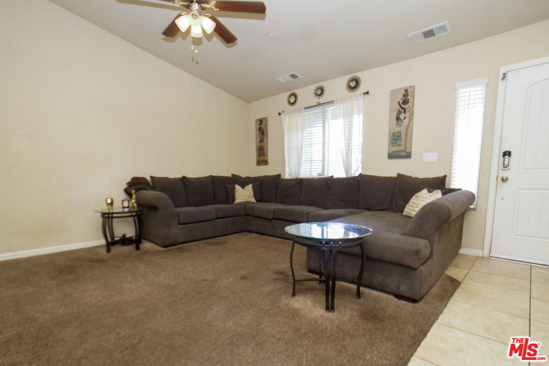 6014 Samuelson Street Bakersfield, CA 93313 - Photo 19 of 25 a living room with furniture and a large mirror