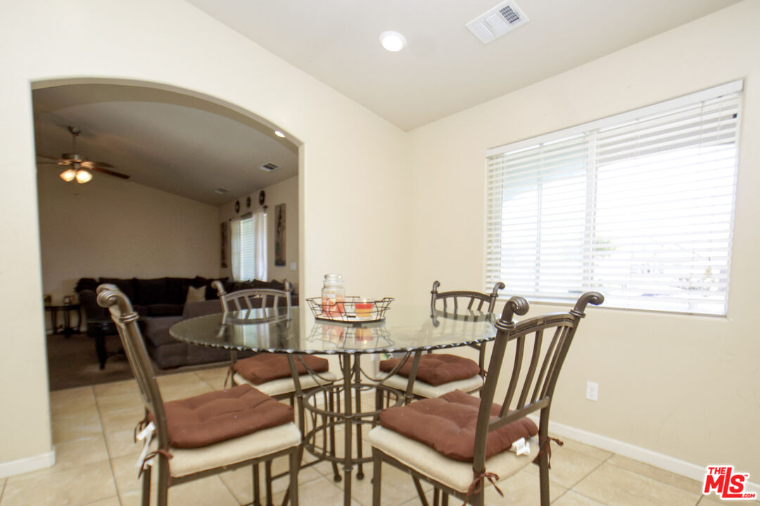 6014 Samuelson Street Bakersfield, CA 93313 - Photo 8 of 25 a view of a dining room with furniture and a large window