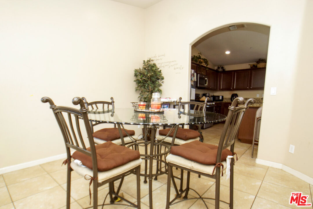 6014 Samuelson Street Bakersfield, CA 93313 - Photo 9 of 25 a dining room with furniture and a chandelier