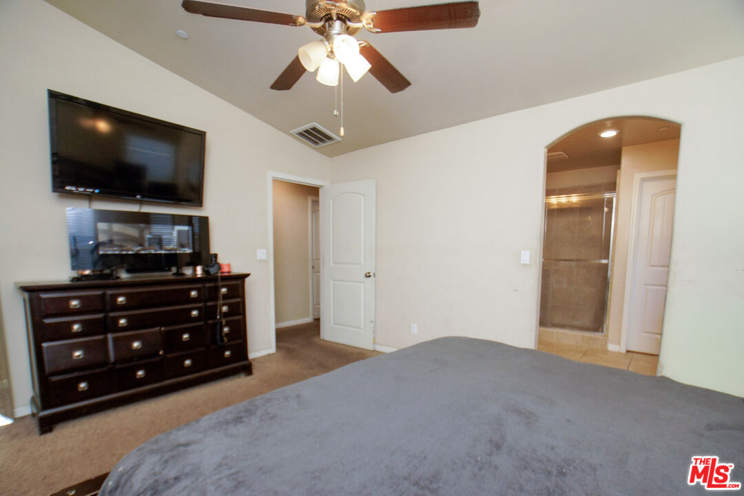 6014 Samuelson Street Bakersfield, CA 93313 - Photo 10 of 25 a bedroom with a bed and a flat screen tv