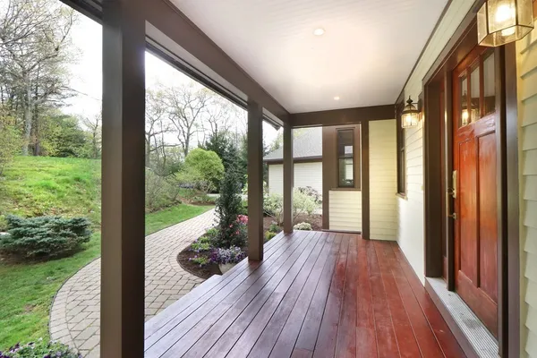 a view of backyard with large trees and wooden floor