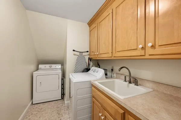 a kitchen with a sink a stove and cabinets