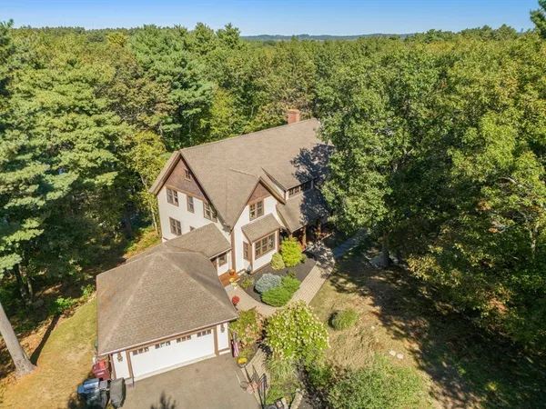 an aerial view of a house with swimming pool and mountain view