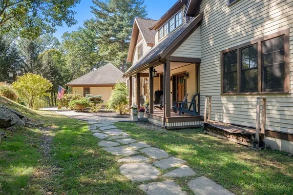 a view of a house with backyard porch and sitting area