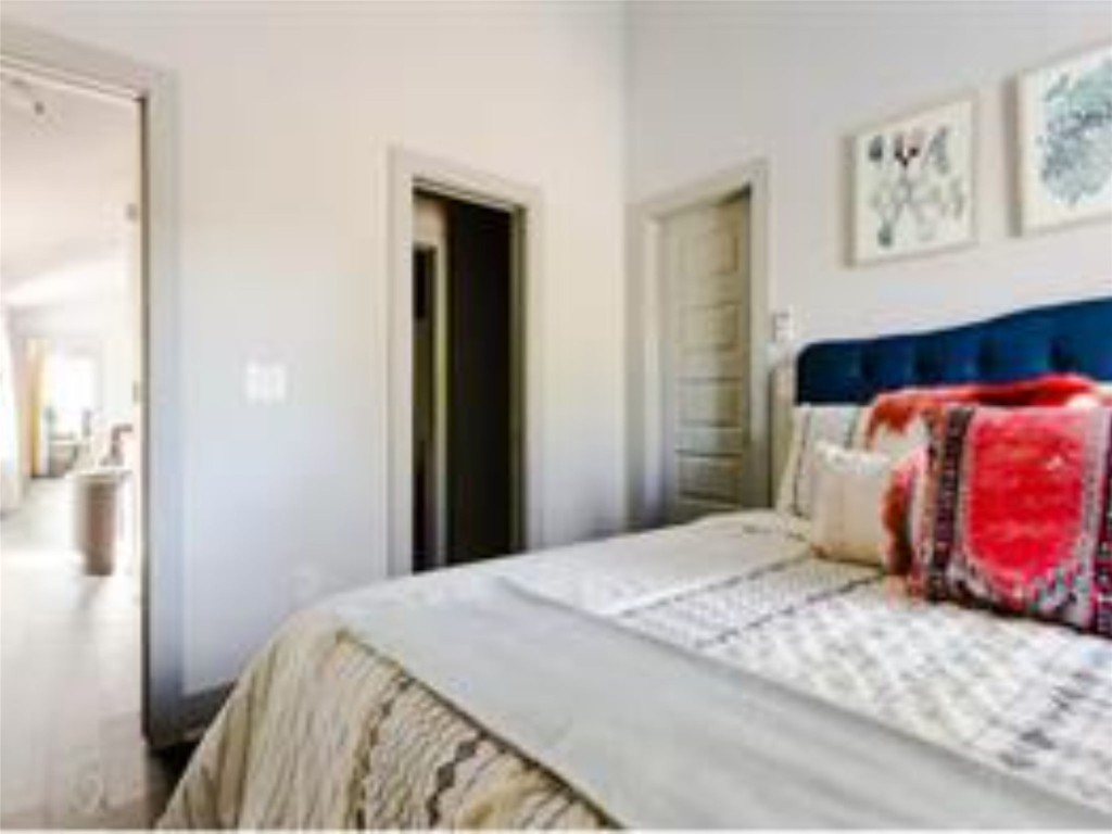 1139 1/2 Poquito Street, Unit 3 Austin, TX 78702 - Photo 11 of 23 a bedroom with a bed and painting on the wall