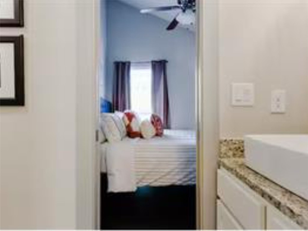 1139 1/2 Poquito Street, Unit 3 Austin, TX 78702 - Photo 13 of 23 a bedroom with a bed and a potted plant