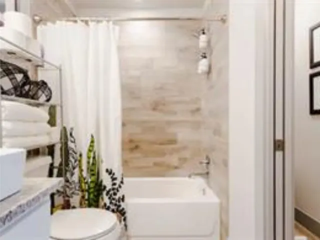 a bathroom with a shower curtain and a sink
