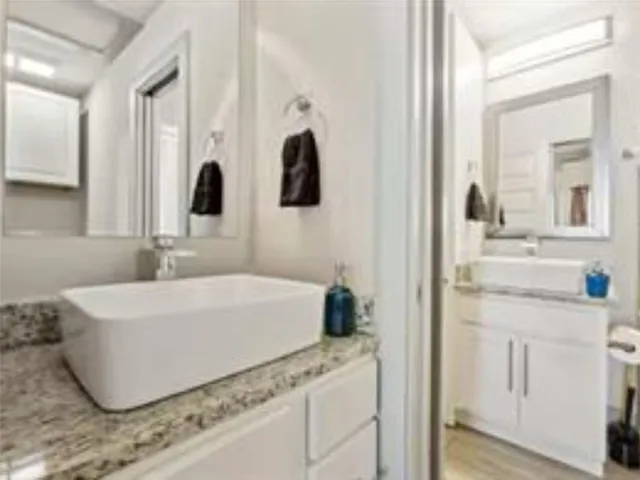 a bathroom with a tub sink and mirror