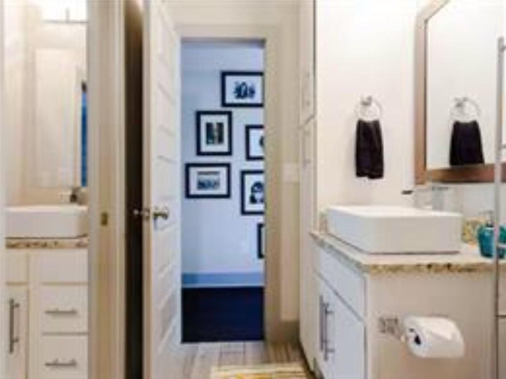 1139 1/2 Poquito Street, Unit 3 Austin, TX 78702 - Photo 16 of 23 a bathroom with a sink and a mirror