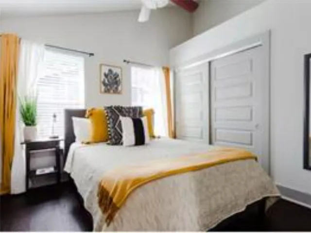 a bedroom with a bed and a window