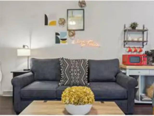 a living room with furniture and painting on the wall