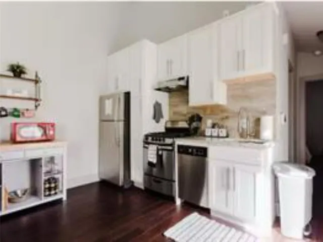a kitchen with stainless steel appliances granite countertop a refrigerator sink and stove