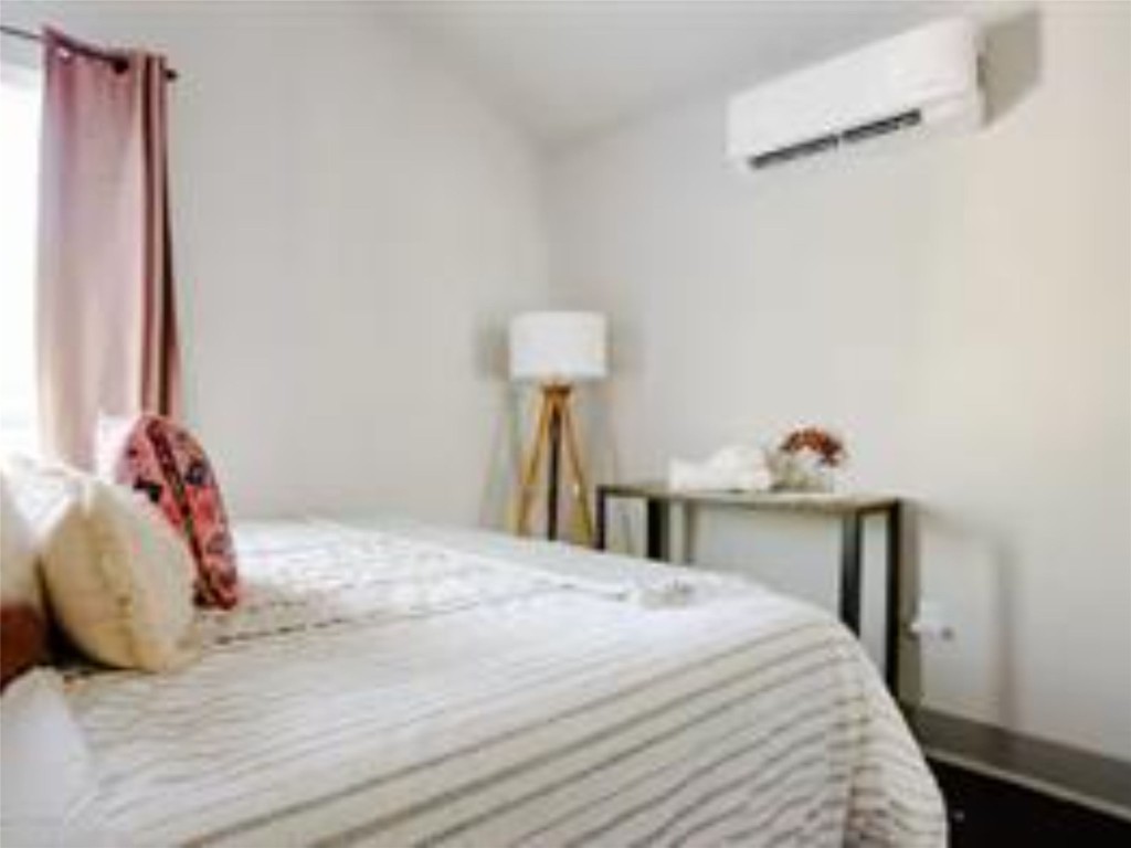 1139 1/2 Poquito Street, Unit 3 Austin, TX 78702 - Photo 10 of 23 a bedroom with a bed and a table