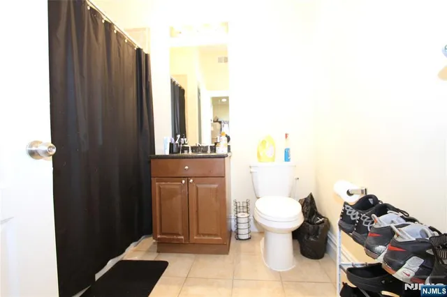 a bathroom with a toilet and a shower curtain